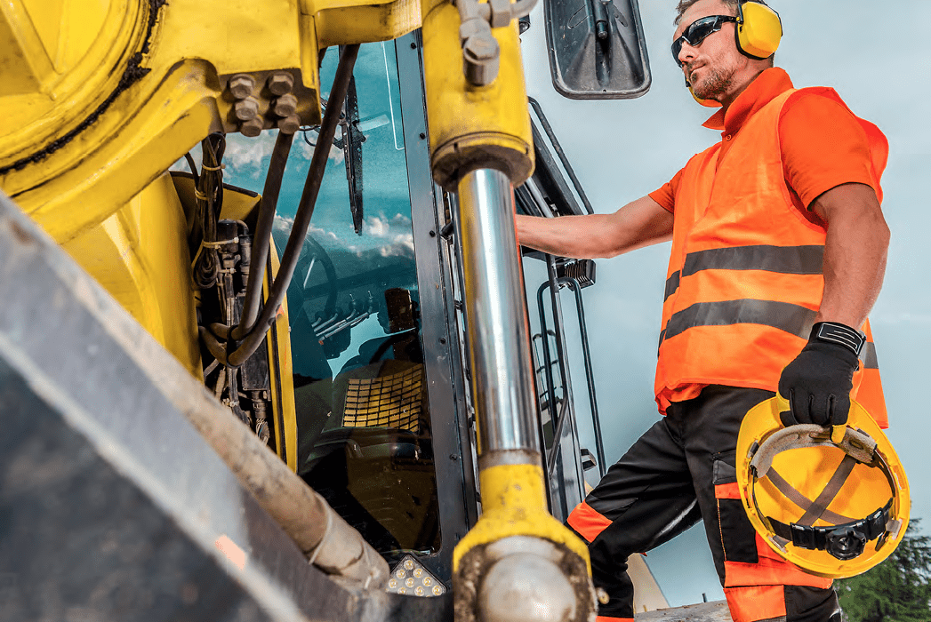 Man standing beside machinery